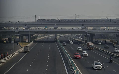 Metro train running on track during the smoggy morning as the air quality dips, in New Delhi. (Photo | ANI)