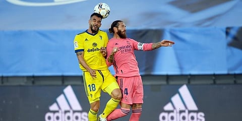Cadiz forward Alvaro Negredo vies with Real Madrid's Sergio Ramos during the Spanish League football match. (Photo | AFP)
