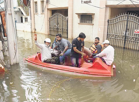 A family being shifted to a safe location after their house at Nadeem Colony in Tolichowki got inundated, on Sunday | RVK Rao
