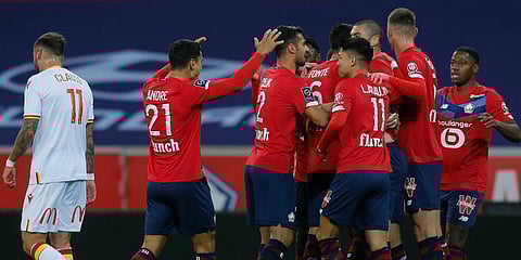 Lille players celebrate after scoring during their French League One soccer match against Lens in Villeneuve d'Ascq. (Photo | AP)