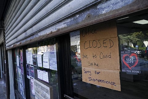 A storefront displays a closed sign as it remains shuttered due to a COVID-19 area infection rate increase in the Far Rockaway neighborhood of the borough of Queens in New York. (Photo | AP)