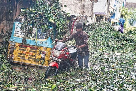 A resident of Hafiz Baba Nagar shifts a bike from a flooded lane in the area on Sunday, a day after heavy rains wreaked havoc in Hyderabad again | vinay madapu
