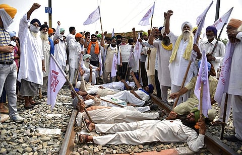 Farmers shout slogans as they block a railway track protesting against the new farm bills, at Devi Dass Pura village, about 20 kilometers from Amritsar, India, Thursday, Sept. 24, 2020. (Photo | AP)