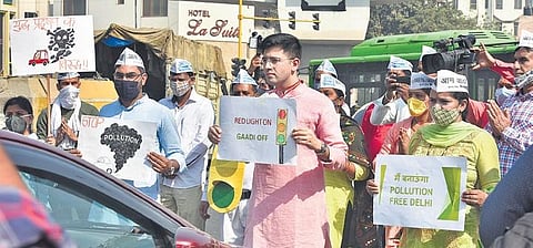 AAP MLA Raghav Chadha (centre) and volunteers urge commuters to do their bit to fight air pollution as part of the ‘Red Light On, Engine Off’ campaign | Express