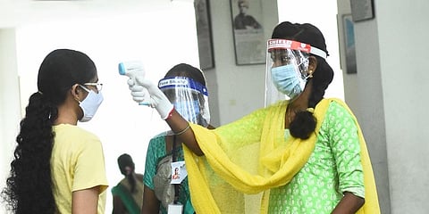 Students who are appearing for the NEET exam being thermal scanned at a center in Adyar. (Photo | Ashwin Prasath, EPS)