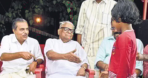 CPM veteran V S Achuthanandan greets a girl who came to the dais at the election convention of LDF Vattiyoorkavu candidate V K Prasanth at Kuravankonam in Thiruvananthapuram on Friday | B P Deepu