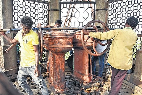 Mechanic Khadeer and his helpers try to open the sluice gates of Fox Sagar lake on Wednesday | rvk rao