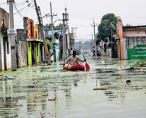 A man uses a boat to wade through high levels of floodwaters at Osman Nagar  in Hyderabad on Wednesday | vinay madapu