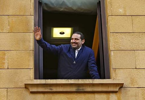 Lebanese Prime Minister Saad Hariri waves to his supporters from a window of his residence. (File Photo | AP)