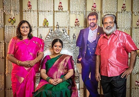 Actress Meghana Raj Sarja with a life-size photo of late husband Chiranjeevi and other family members on her baby shower. (Photo | Meghana Raj Sarja, Instagram)