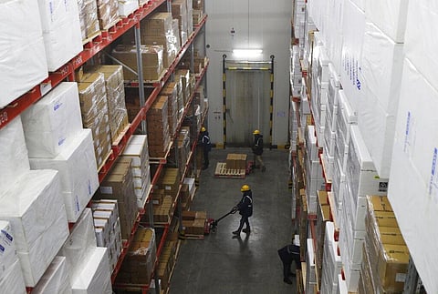 Workers move boxes inside Snowman Logistics, India's largest cold storage company in Taloja on the outskirts of Mumbai, India, Saturday, Oct. 17, 2020. (Photo | AP)