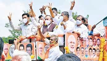 Panchayat Raj Minister K S Eshwarappa and BJP state unit vice-president B Y Vijayendra during a rally in Sira on Friday