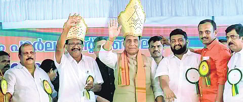 Union Home Minister Rajnath Singh and NDA candidate P C Thomas wave at the audience during a poll-related meeting held at Nagambadom ground in Kottayam (File photo)