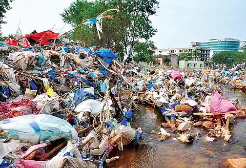 Medical waste and PPE kits, which were dumped in Appa lake near Gaganpahad, float around in nearby residential areas | RVK Rao