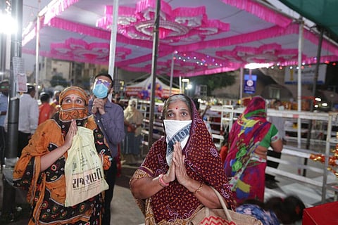 An Indian devotee offer prayers in front of an LED screen set up outside Bhadrakali temple during Navratri, or festival of nine nights, in Ahmedabad, India, Saturday, Oct. 24, 2020. (Photo | AP)