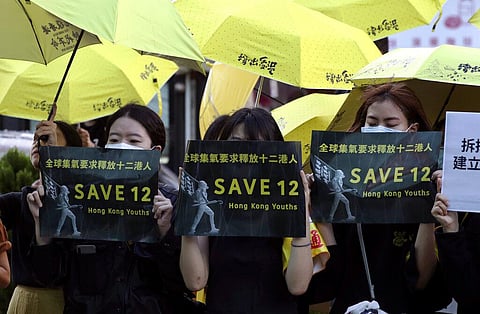 Supporters gather, holding slogan to demand the release of the 12 Hong Kong protesters that have been arrested by mainland Chinese authorities, in Taipei, Taiwan, Sunday, Oct. 25, 2020. (Photo | AP)