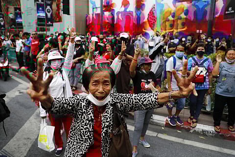Pro-democracy protesters gather, flashing three-fingered salutes near a main shopping district in Bangkok, Thailand, Sunday, Oct. 25, 2020. (Photo | AP)