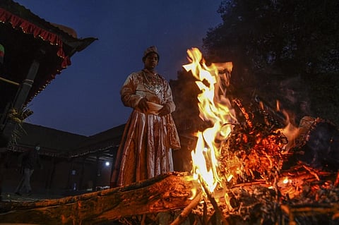 A Hindu priest stands in front of a fire at the Baramahini Temple during the tenth day of Dashain festival in Nepal. (Photo| AFP)