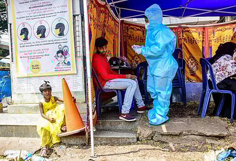 Health workers collecting swab at KSRTC Bus stand in Bengaluru on Monday. (Photo | Shriram BN/EPS)