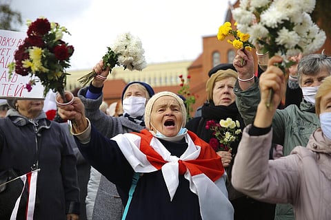 People, most of them pensioners, wave bunches of flowers during an opposition rally to protest the official presidential election results in Minsk, Belarus. (Photo | AP)