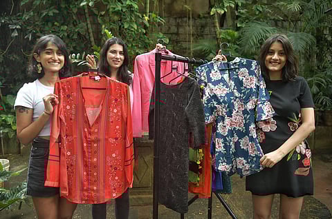 (From left) Akshaya Maller, Sera Minocher and Rhea Subramanian display clothes from their thrift shop. (Photo | Meghana Sastry, EPS)