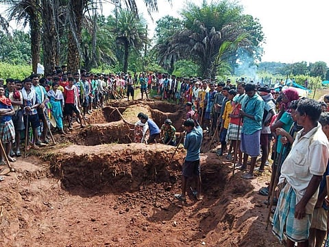 The villagers stand next to the trenches they dug up on the road leading to interior areas (Photo | EPS)