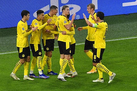 Dortmund's Jadon Sancho, second left, celebrates after scoring his side's opening goal from the penalty spot. (Photo | AP)