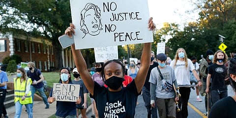 University of Georgia students march down Milledge Avenue during a march and caravan for Breonna Taylor on Friday. (Photo | AP)
