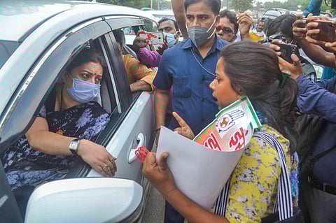 A Congress party activist protests near the vehicle of Union Minister Smriti Irani. (Photo| PTI)