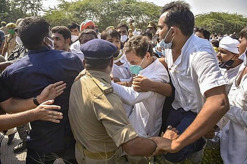 Congress leader Rahul Gandhi slumps after police personnel allegedly manhandled him while he was on his way to Hathras along with party workers. (Photo | PTI)