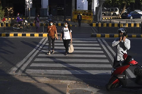 Pedestrians wearing facemasks as a preventive measure against the COVID-19 Coronavirus. (Photo| AFP)