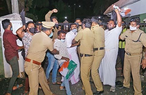 Police removing Youth Congress workers who sneaked into the high-security area and reached the gate of Cliff House, the official residence of CM Pinarayi, in Thiruvananthapuram on Friday. |  Express