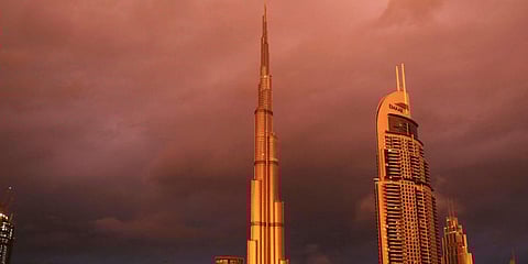 Sunlight reflects off the Burj Khalifa, the world's tallest building, during a rain shower in Dubai. (File photo| AP)