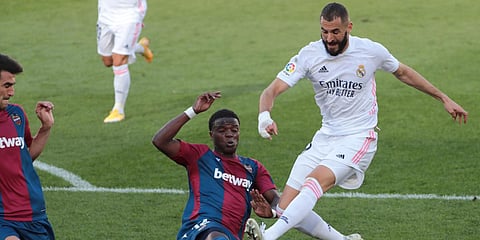 Real Madrid's Karim Benzema (R) duels for the ball with Levante's Mickael Malsa during a La Liga soccer match at the Ceramica stadium in Villarreal. (Photo| AP)