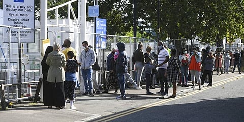 People queue up outside a coronavirus testing centre offering walk-in appointments in north London. (Photo | AP)