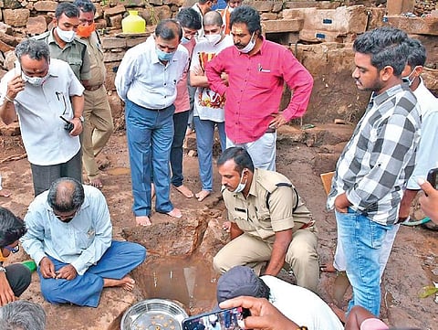 Officials inspect the gold and silver coins (inset) unearthed from the Srisailam temple premises on Sunday | EXPRESS