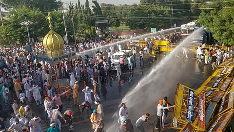 Police personnel use water cannons to disperse farmers during a massive protest against the new farm bills in Sirsa district Tuesday (Photo | PTI)
