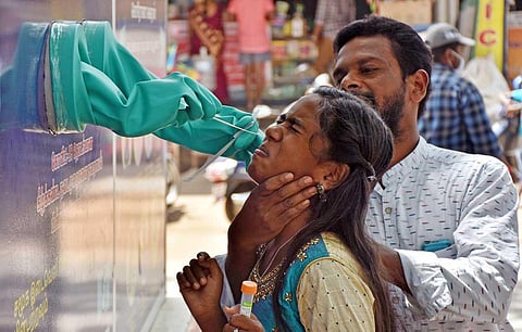 Health worker collects nasal swabs for Covid-19 at a sample collection unit. (Photo | U Rakesh Kumar, EPS)