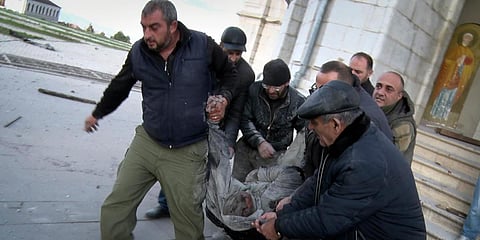 People carry out an injured man from the Holy Savior Cathedral after shelling the Cathedral by Azerbaijan's artillery during a military conflict in Nagorno-Karabakh. (Photo| AP)