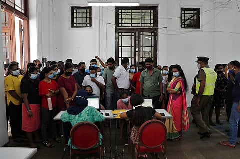 Employees of Colombo municipal council crowd around a table to give their swab samples to test for COVID-19 in Colombo, Sri Lanka, Wednesday, Oct. 7, 2020. (Photo | AP)