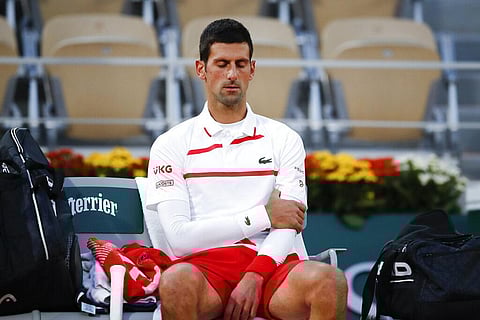 Serbia's Novak Djokovic massages his left upper arm in the quarterfinal match of the French Open tennis tournament against Spain's Pablo Carreno Busta (Photo | AP)