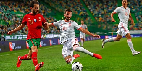 Portugal's Bernardo Silva is challenged by Spain's Gaya during the international friendly at the Jose Alvalade stadium in Lisbon. (Photo | AP)