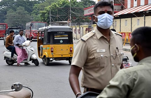 Police charging fine for those roaming without masks at Egmore in Chennai. (Photo | R.Satish Babu, EPS)