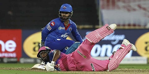 Rajasthan Royals batsman Sanju Samson falls on the ground during a IPL 2020 match against Delhi Capitals. (Photo| PTI)
