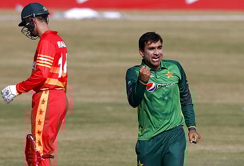 Pakistani spinner Iftikhar Ahmed, right, celebrates after taking the wicket of Zimbabwe's batsman Tendai Chisoro. (Photo | AP)