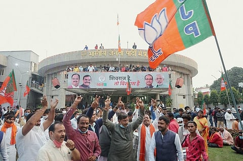 BJP workers celebrate the party's victory in Madhya Pradesh Assembly by-elections, at BJP State headquarters in Bhopal. (Photo | PTI)