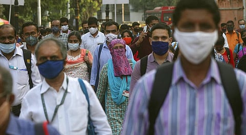 Passengers wearing masks arrive at the Chhatrapati Shivaji Maharaj train terminus in Mumbai, India, Monday, Nov. 9, 2020. (Photo | AP)
