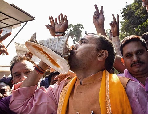 BJP supporters celebrate NDA's lead during the counting of votes for the Bihar Assembly Elections results in Patna Tuesday. (Photo | PTI)