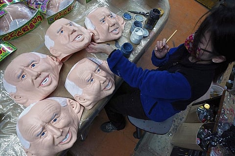 An employee adds details to rubber masks depicting President-elect Joe Biden at the Ogawa Studios in Saitama, Tokyo. (Photo | AP)