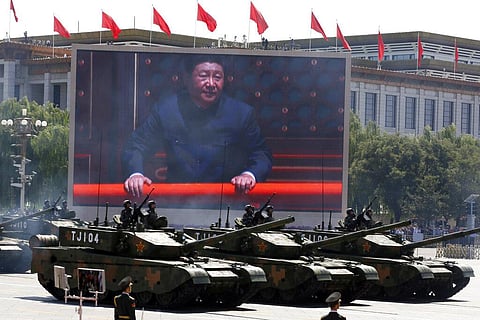 Chinese President Xi Jinping is displayed on a screen as Type 99A2 Chinese battle tanks take part in a parade. (Photo | AP)